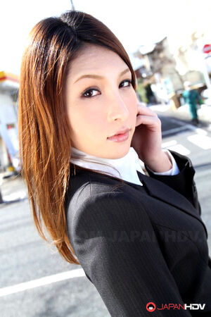 Hot redhead japanese girl in suit poses to show her beautiful face